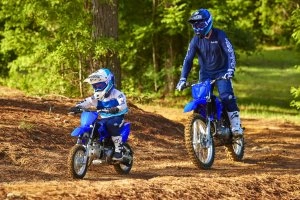 Man and kid riding in the woods 2