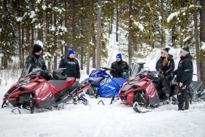 Riders prepare to board their snowmobiles
